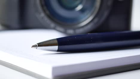 camera, pen, and notebook