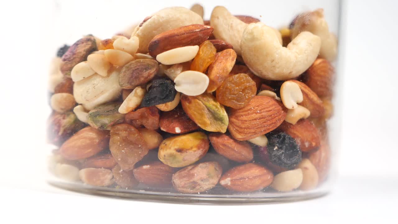 Close-up of a Glass Jar Filled with a Mix of Nuts and Dried Fruits