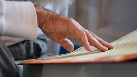 a man's hand reading from the quran