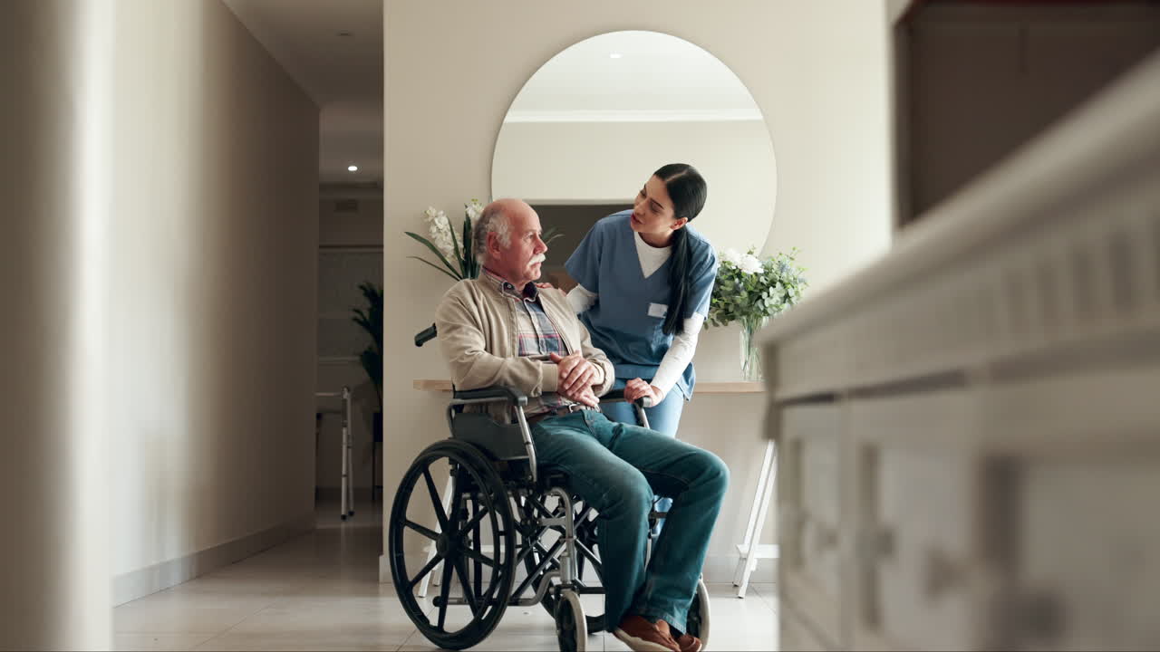 Nurse assisting senior man in wheelchair