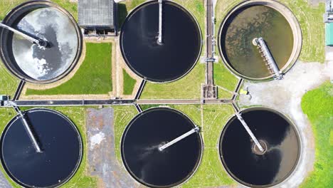 aerial top view of circular ponds in wastewater treatment plant and filtration of dirty sewage water