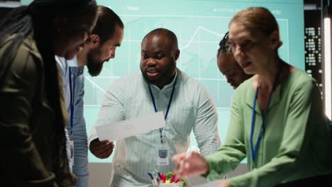 night time meeting unfolds as a multiethnic team gathers in a strategy room