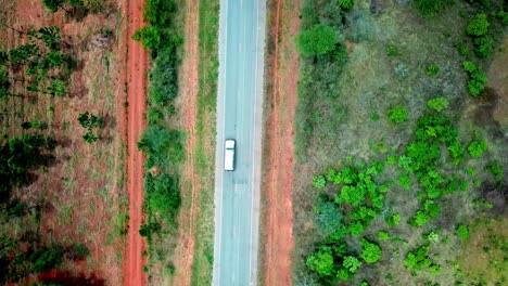 Overhead-View-Of-White-Van-Driving-On-The-Empty-Road