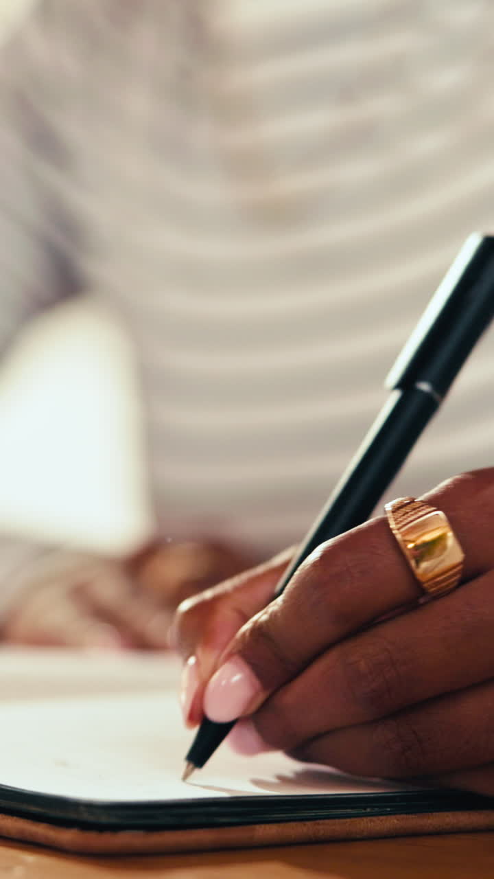 Close Up of Hand Writing with Pen on Paper