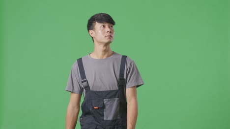 man in work uniform against green screen