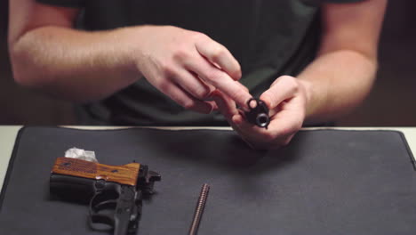 gun owner reassembles beretta handgun