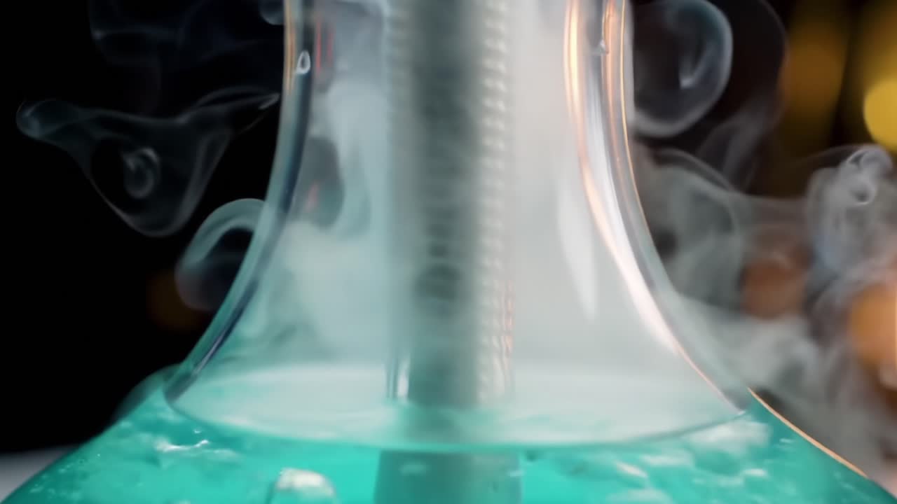 Close-up of Colorful Liquid Bubbling and Smoke Rising in Unique Glass Setup