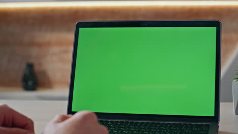 businessman looking greenscreen laptop waiting online conference at desk closeup