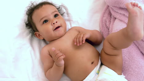 Smiling-baby-on-bed