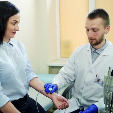 doctor talking with patient. young male doctor talking to female patient
