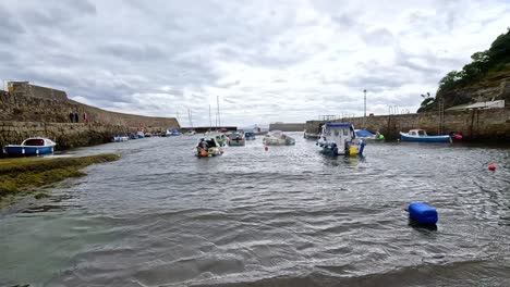 boats moving through a port in fife