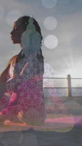 white spots of light falling against african american fit woman performing yoga on the promenade