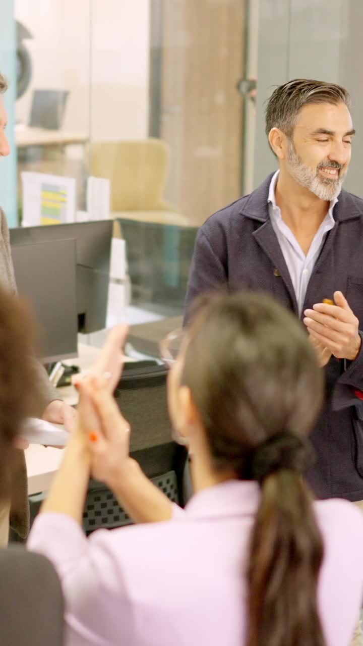 Employees applauding to the boss in a coworking space