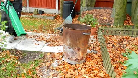 Clearing-leaves-in-windy-garden-with-leaf-blower-vacuum