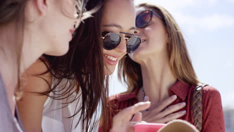 teenage girls using mobile phone sharing photo of summer vacation on social media close up portrait