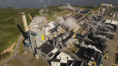 smoking chimneys of paper mill factory, fray bentos in uruguay