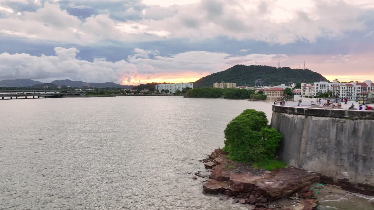 Drone shot of Las bobedas in Casco Antiguo Panama, while Ancón Hill is revealed in the background during sunset