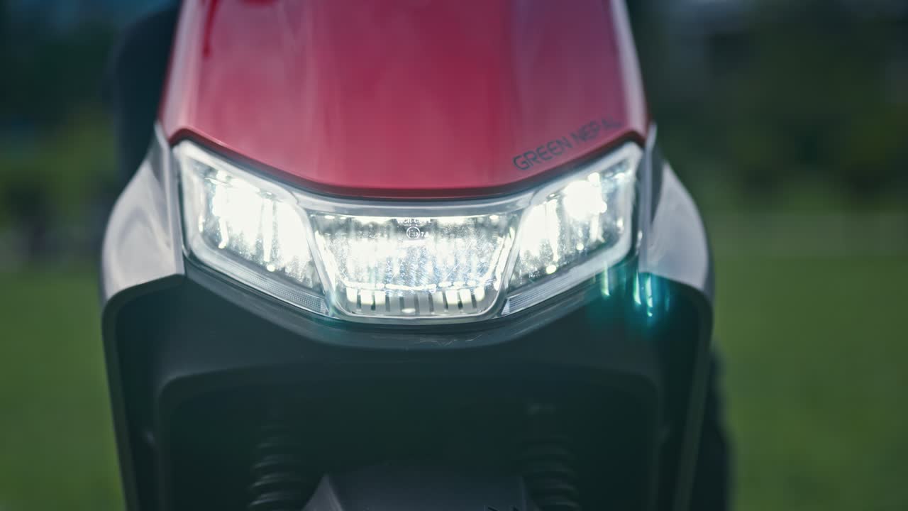 Footage of an electric scooter headlight turning on and off. Highlights lighting system, control switch, and electric mobility technology in detail