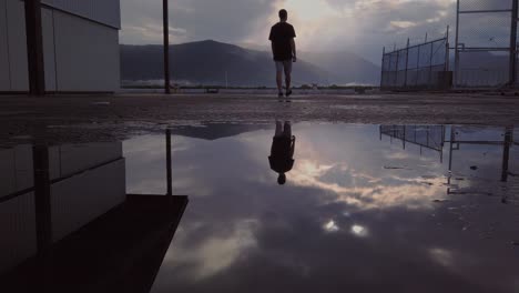 A man walking to the edge of a property to admire the beautiful view of the mountains of Australia - low angle