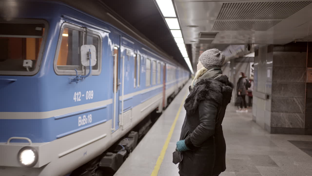 Woman waiting for a train at a subway station