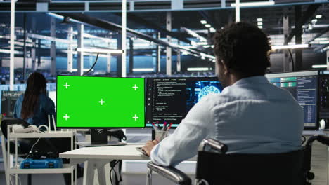 data center admin in wheelchair using ai node tree software on green screen pc