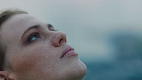 close-up-portrait-of-beautiful-young-woman-looking-up-praying-exploring-spirituality-contemplating-future-on-cloudy-seaside