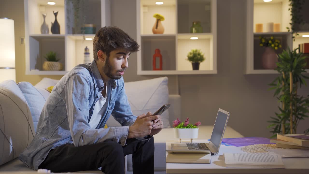 Man lying on sofa is using phone. Pleasant and comfortable posture.