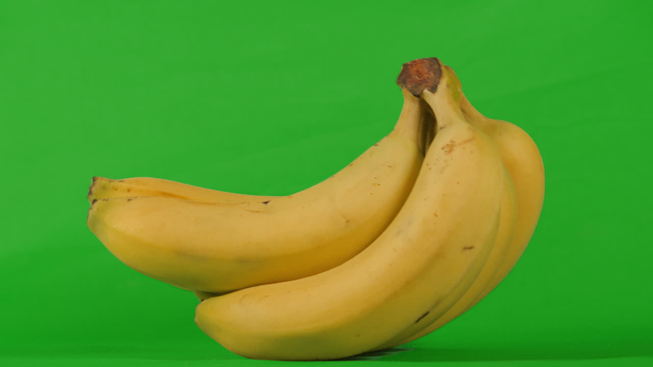 Bunch of Bananas Rocking on Green Screen in Slow Motion. Chromakey Background to Isolate and Add to Your Video. ProRes 4K.