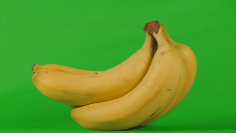 bunch of bananas rocking on green screen in slow motion. chromakey background to isolate and add to your video. prores 4k.