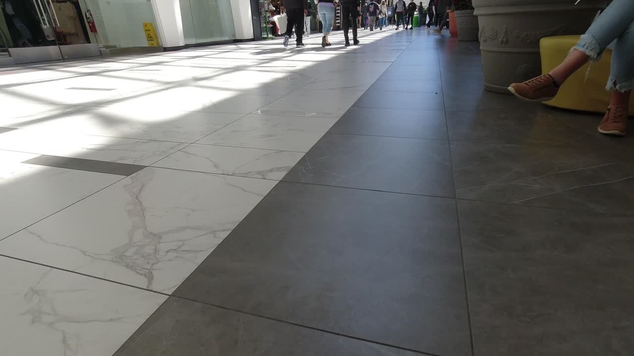 Crowd walking by in a mall.