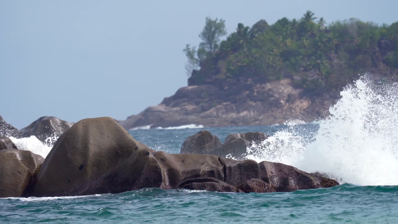 Waves crushing on the granite stones near the reef of Mahe island, Seychelles, 30fps