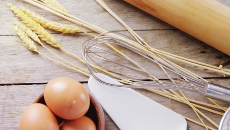 brown eggs, barley crop and various ingredients on wooden table 4k