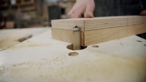 close up. the master processes wood on the machine in the woodworking workshop of a small furniture manufacturer. slow motion vercion 2