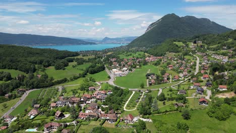 lake annecy and perroix mountain village panorama in french alps - aerial