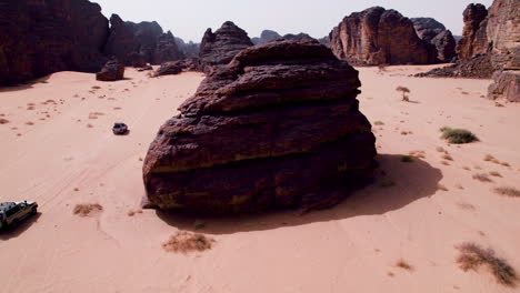 suv cars navigating on sahara desert through rock formations