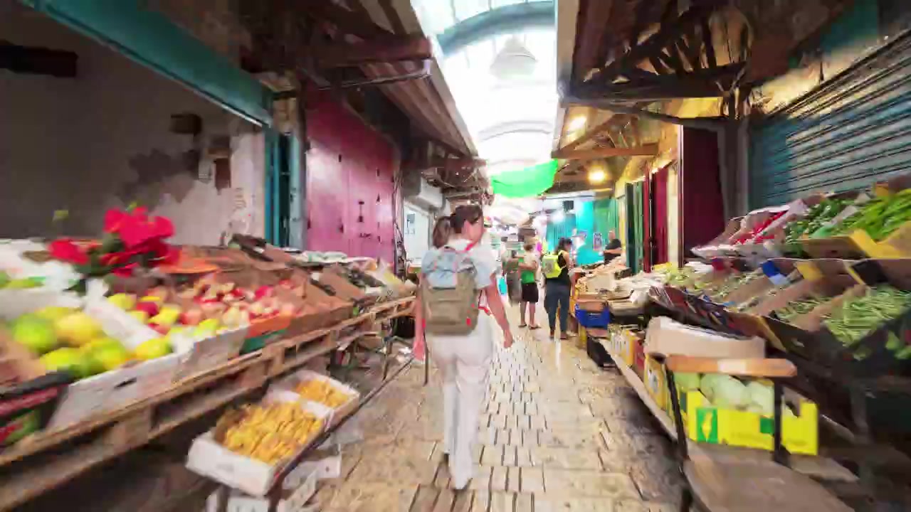 Hyperlapse walking through colorful traditional market stalls in Old City streets