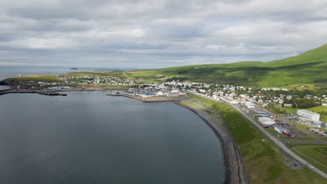 embrace húsavík from above in this 4k drone sweep, capturing the town's full charm, framed by the serene waters that cradle its shores