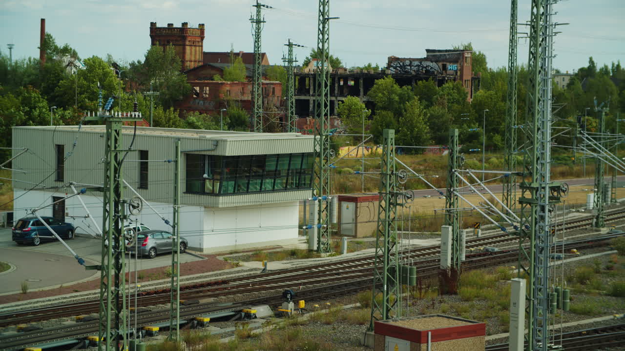 red locomotive electric loco passing rail controll center