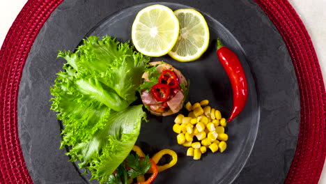 Close-up-of-well-decorated-ceviche-on-a-slate-plate