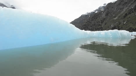 close up tracking motion from a boat of an iceberg in endicott arm in tracy arm