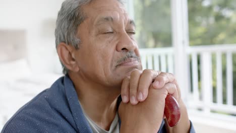 Portrait-of-biracial-senior-man-with-walking-stick-at-home,-slow-motion