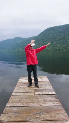 woman wearing vr headset on a wooden dock by a lake