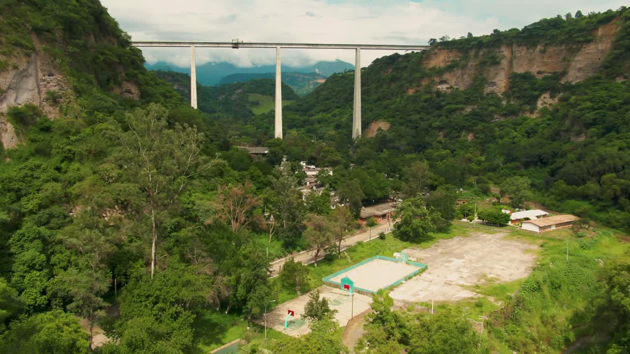 Drone footage of a tilt up shot in town of Atenquique, Jalisco, with bridge in background
