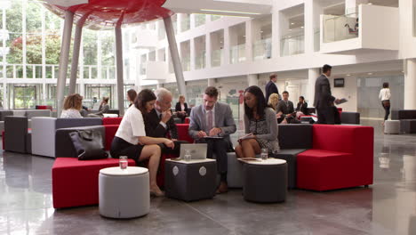 Businesspeople-Meeting-In-Lobby-Of-Modern-Office-Shot-On-R3D