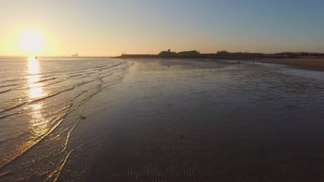 Aerial:-The-boulevard,-beach-and-city-of-Vlissingen-during-sunset