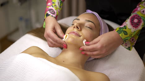 woman receives relaxing facial skincare treatment at a spa