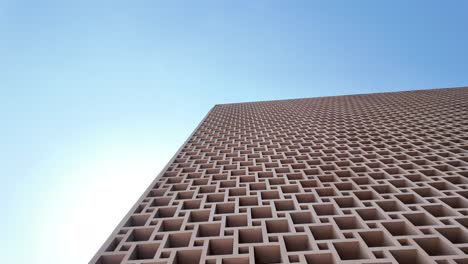 modern geometric building facade against clear sky