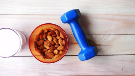 almond milk and almonds with dumbbell