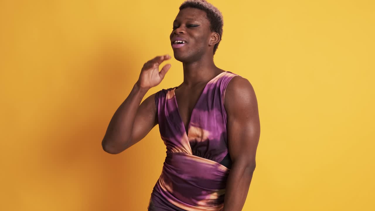 African trans man with sensual dress posing in a photographic studio