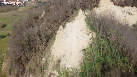 zooming in aerial flying drone shot over prehistoric age canyons le balze natural reserve near reggello. tuscany, chianti area. italy. winter season, partially sunny sunset.